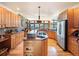 Gourmet kitchen featuring custom cabinets, stainless appliances, granite countertops, and mountain views from the large windows at 76 Raven Ridge Rd, Idaho Springs, CO 80452
