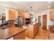Bright kitchen with wood cabinets, granite counters, stainless steel appliances, and a large island cooktop at 76 Raven Ridge Rd, Idaho Springs, CO 80452