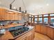 Well-lit kitchen with wooden cabinets, stone countertops, and mountain views at 76 Raven Ridge Rd, Idaho Springs, CO 80452