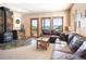 Living room features a cozy wood burning stove and breathtaking mountain views at 76 Raven Ridge Rd, Idaho Springs, CO 80452