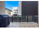 Open-air balcony with grill features outdoor space with glass railings and views of city architecture at 250 Columbine St # 310, Denver, CO 80206