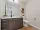 Modern half bathroom with sleek vanity, wood floors, white walls, and marble countertop at 250 Columbine St # 310, Denver, CO 80206