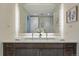 Contemporary bathroom with double vanity, modern lighting, and decorative artwork at 250 Columbine St # 310, Denver, CO 80206