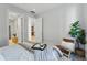 Sunlit bedroom with a comfortable chair, textured bedding and access to a modern kitchen at 250 Columbine St # 310, Denver, CO 80206