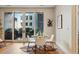 Bright dining area with hardwood floors, glass table, and sliding glass door to balcony at 250 Columbine St # 310, Denver, CO 80206