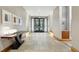 Neutral hallway featuring tiled floor, dark wood accents, and recessed lighting leads to glass doors at 250 Columbine St # 310, Denver, CO 80206
