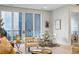Bright living room with modern furniture, hardwood floors, neutral walls, and a sliding glass door to a balcony at 250 Columbine St # 310, Denver, CO 80206
