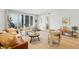 Bright living room with modern furniture, hardwood floors, neutral walls, and a sliding glass door to a balcony at 250 Columbine St # 310, Denver, CO 80206