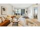 Bright living room with modern furniture, hardwood floors, neutral walls, and a sliding glass door to a balcony at 250 Columbine St # 310, Denver, CO 80206