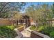 Outdoor grill area in private landscaped courtyard with pathway, stone wall, and mature trees at 250 Columbine St # 310, Denver, CO 80206