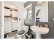 Half bathroom featuring modern sink and laundry units at 18865 E 57Th Ave # B, Denver, CO 80249