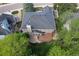 Aerial view of a home showcasing a spacious backyard with a deck, mature trees, and well-maintained landscaping at 2141 Weatherstone Cir, Highlands Ranch, CO 80126