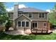 Backyard view features a well-maintained lawn, wooden deck, and mature trees for enjoying the outdoors at 2141 Weatherstone Cir, Highlands Ranch, CO 80126