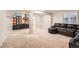 Spacious finished basement area with a mural and a black leather couch at 2141 Weatherstone Cir, Highlands Ranch, CO 80126