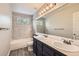 Bathroom featuring double sinks, decorative shower, and modern finishes at 2141 Weatherstone Cir, Highlands Ranch, CO 80126