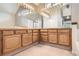 Bathroom with dual sink vanity, bright lighting, and large mirrors at 2141 Weatherstone Cir, Highlands Ranch, CO 80126
