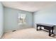 Carpeted bedroom with blue walls and a desk at 2141 Weatherstone Cir, Highlands Ranch, CO 80126