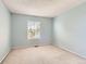 Neutral bedroom featuring light-blue walls, carpet, and natural light from a window at 2141 Weatherstone Cir, Highlands Ranch, CO 80126