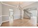 Elegant dining room boasting hardwood floors, classic chandelier, and seamless access to the staircase at 2141 Weatherstone Cir, Highlands Ranch, CO 80126