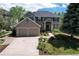 Beautiful two-story home showcasing a well-manicured front yard and a two-car garage at 2141 Weatherstone Cir, Highlands Ranch, CO 80126