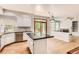 Open kitchen with wood-topped island, stainless steel appliances, and access to a cozy living space at 2141 Weatherstone Cir, Highlands Ranch, CO 80126