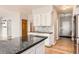 Kitchen with stainless steel refrigerator, island and white cabinetry with wood countertops at 2141 Weatherstone Cir, Highlands Ranch, CO 80126