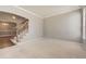 Bright living room featuring a staircase, carpeted floor, and natural light from the window at 2141 Weatherstone Cir, Highlands Ranch, CO 80126
