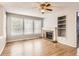 Inviting living room with a brick fireplace, built-in shelving, and plenty of natural light at 2141 Weatherstone Cir, Highlands Ranch, CO 80126