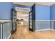 Room featuring hardwood floors, French doors leading to the kitchen, and decorative wallpaper at 2141 Weatherstone Cir, Highlands Ranch, CO 80126