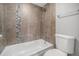 Cozy bath with decorative shower tile, and modern fixtures at 3047 W 47Th Ave # 109, Denver, CO 80211