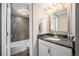 Stylish bathroom featuring granite vanity and bath tub with decorative tile at 3047 W 47Th Ave # 109, Denver, CO 80211