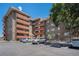 Multi-story brick apartment building featuring balconies, covered parking and a neatly maintained facade at 3047 W 47Th Ave # 109, Denver, CO 80211