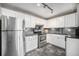 Well-lit kitchen with white cabinets, stainless steel appliances, and tile backsplash at 3047 W 47Th Ave # 109, Denver, CO 80211