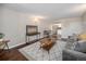 Cozy living room with sofa, wood floors, entertainment center and adjacent dining area at 3047 W 47Th Ave # 109, Denver, CO 80211