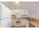 Efficient kitchen with white cabinets, laminate countertops, and essential appliances at 7683 S Steele St, Centennial, CO 80122