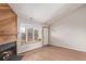 Bright living room featuring a fireplace, wood floors, and a bay window with a built-in bench at 7683 S Steele St, Centennial, CO 80122