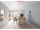 Virtually staged dining room with a wooden table and chairs at 12423 E Louisiana Ave, Aurora, CO 80012