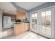 Kitchen with light wood cabinets, white appliances, and access to a deck at 12423 E Louisiana Ave, Aurora, CO 80012