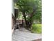 Backyard with lush trees, a deck, and brick siding on house at 3566 E Fair Pl, Centennial, CO 80121