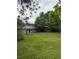Spacious backyard with mature trees, open lawn space, and a view of the home's rear exterior at 3566 E Fair Pl, Centennial, CO 80121