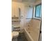 Bright bathroom with tiled shower, built-in shelving, and modern fixtures at 3566 E Fair Pl, Centennial, CO 80121