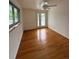 Bright bedroom features hardwood floors, natural light, and doors to the outside deck at 3566 E Fair Pl, Centennial, CO 80121