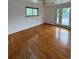 Spacious bedroom features hardwood floors, natural light, and access to an outdoor deck at 3566 E Fair Pl, Centennial, CO 80121