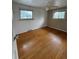Bright bedroom featuring hardwood floors, a ceiling fan and two windows that provide natural light at 3566 E Fair Pl, Centennial, CO 80121
