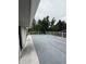 Outdoor deck with white railing overlooking lush trees and neighborhood views at 3566 E Fair Pl, Centennial, CO 80121