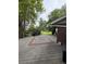A large, shaded deck area is shown, featuring patterned inlays, and provides backyard access at 3566 E Fair Pl, Centennial, CO 80121