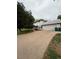 The extended driveway, accented by a manicured yard, leads to a two car garage at 3566 E Fair Pl, Centennial, CO 80121