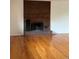 Brick fireplace compliments the hardwood floors and white walls of the living room at 3566 E Fair Pl, Centennial, CO 80121
