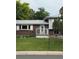 Close-up of the home's brick facade with a storm door and a small porch with white railings at 3566 E Fair Pl, Centennial, CO 80121