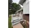 The porch with grey composite decking looks out over the front yard of this home at 3566 E Fair Pl, Centennial, CO 80121